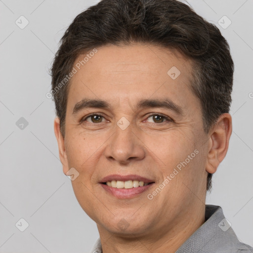 Joyful white adult male with short  brown hair and brown eyes