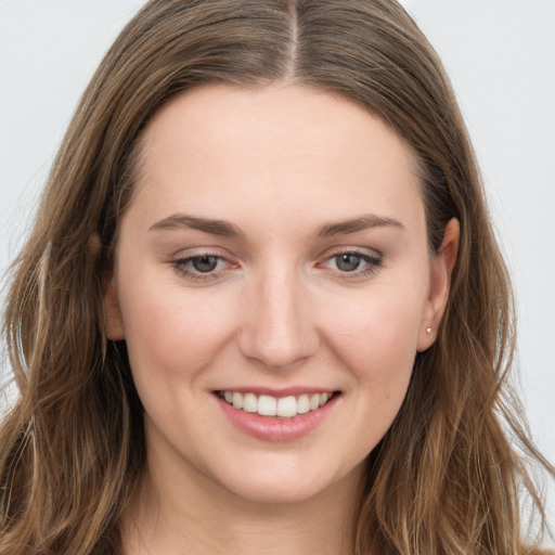 Joyful white young-adult female with long  brown hair and grey eyes