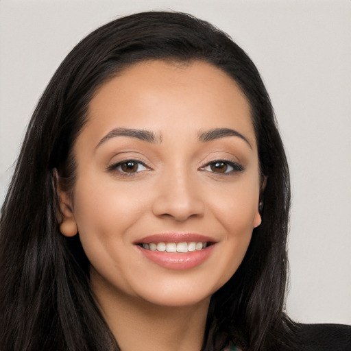 Joyful latino young-adult female with long  black hair and brown eyes