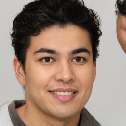 Joyful latino young-adult male with short  brown hair and brown eyes