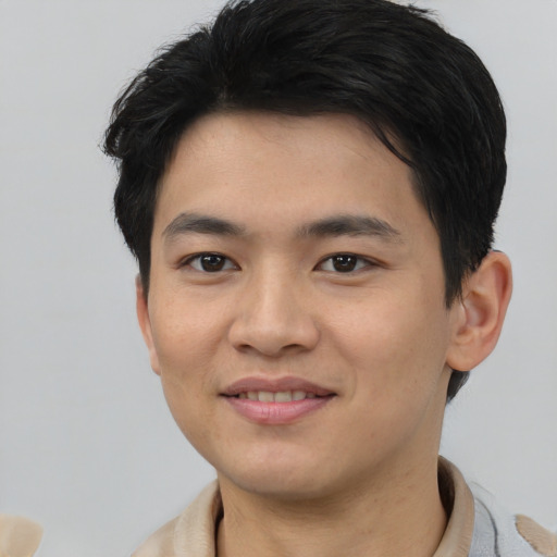 Joyful asian young-adult male with short  brown hair and brown eyes