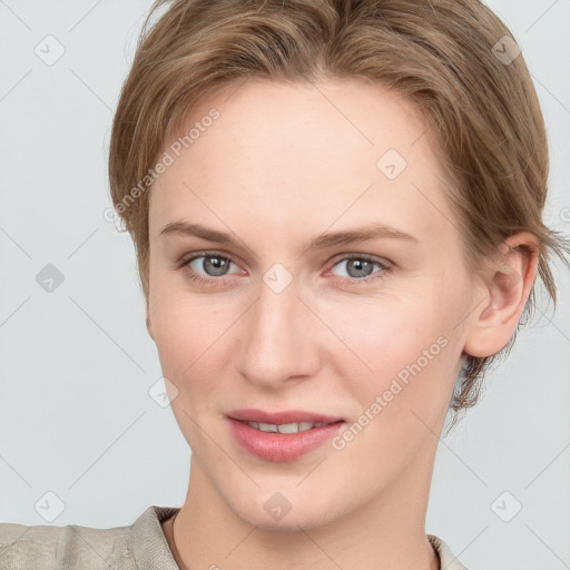 Joyful white young-adult female with short  brown hair and grey eyes