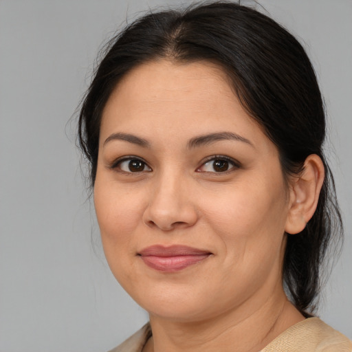 Joyful asian young-adult female with medium  brown hair and brown eyes