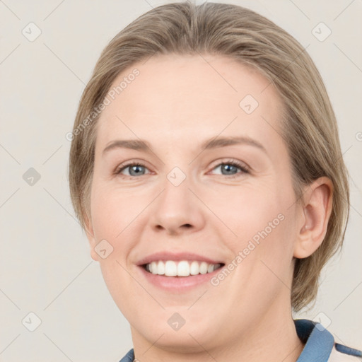 Joyful white young-adult female with medium  brown hair and blue eyes