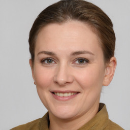 Joyful white young-adult female with short  brown hair and grey eyes