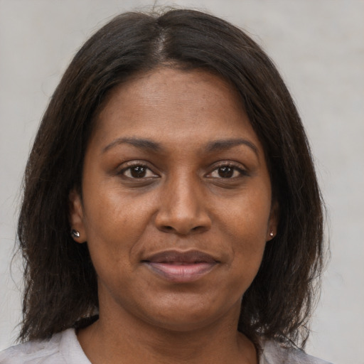 Joyful asian adult female with medium  brown hair and brown eyes