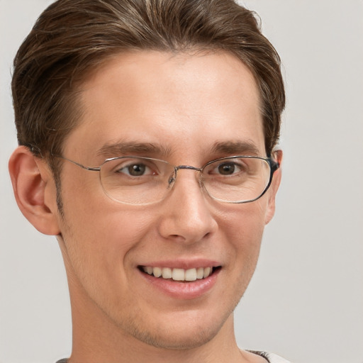 Joyful white adult male with short  brown hair and grey eyes