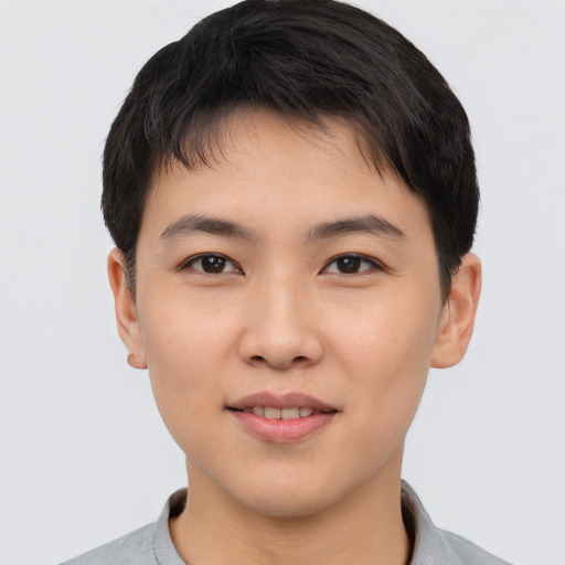 Joyful asian young-adult male with short  black hair and brown eyes