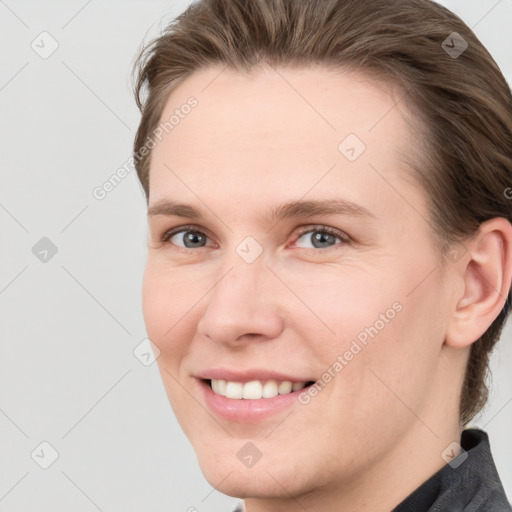 Joyful white young-adult female with short  brown hair and grey eyes