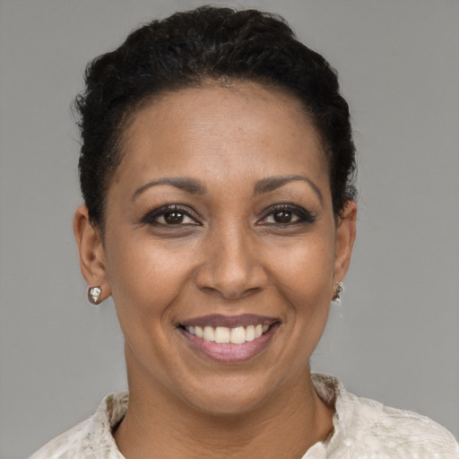 Joyful latino young-adult female with short  brown hair and brown eyes