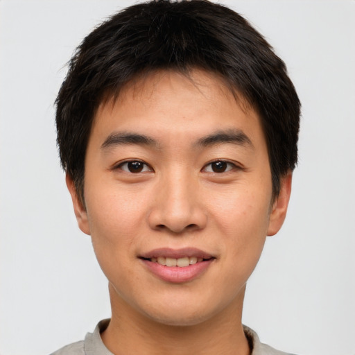 Joyful asian young-adult male with short  brown hair and brown eyes