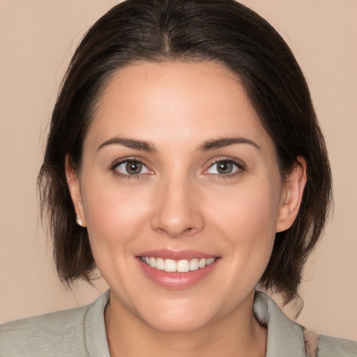 Joyful white young-adult female with medium  brown hair and brown eyes