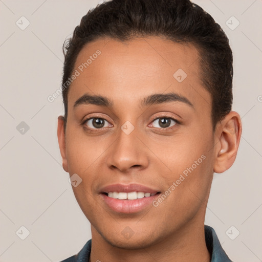 Joyful white young-adult male with short  brown hair and brown eyes