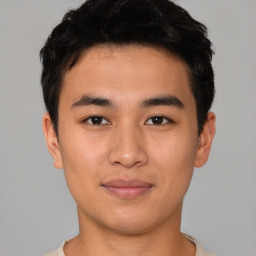 Joyful asian young-adult male with short  black hair and brown eyes