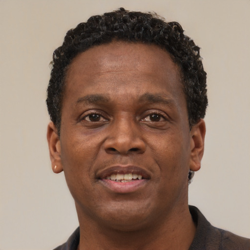Joyful latino adult male with short  brown hair and brown eyes