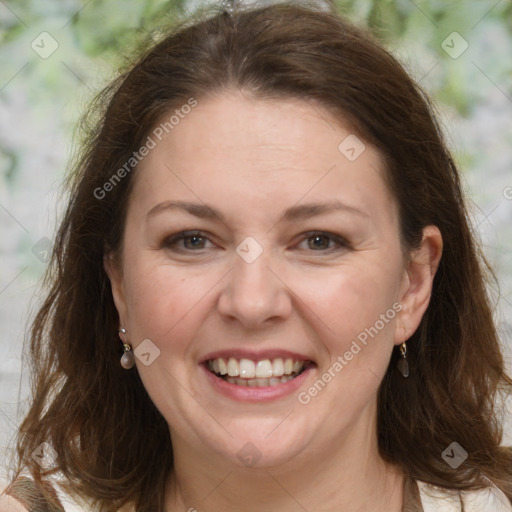 Joyful white adult female with long  brown hair and grey eyes