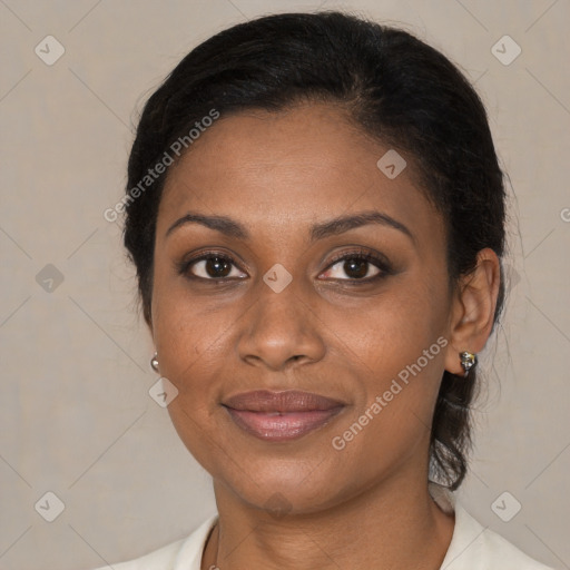 Joyful black adult female with medium  brown hair and brown eyes