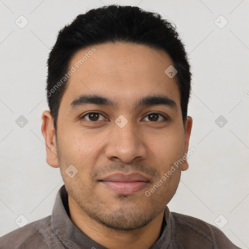 Joyful latino young-adult male with short  black hair and brown eyes