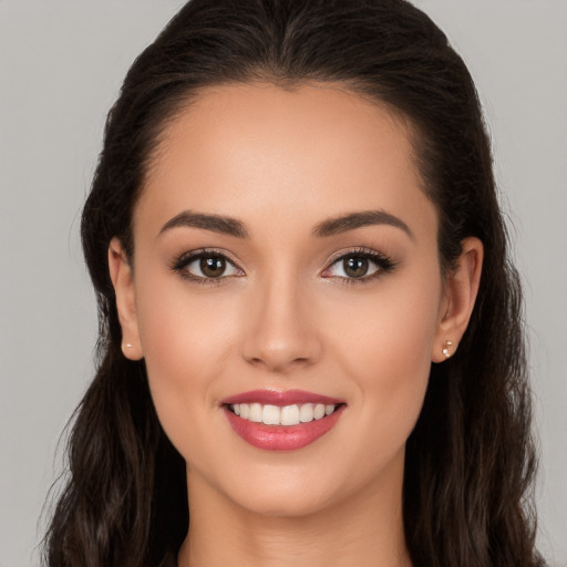 Joyful white young-adult female with long  brown hair and brown eyes