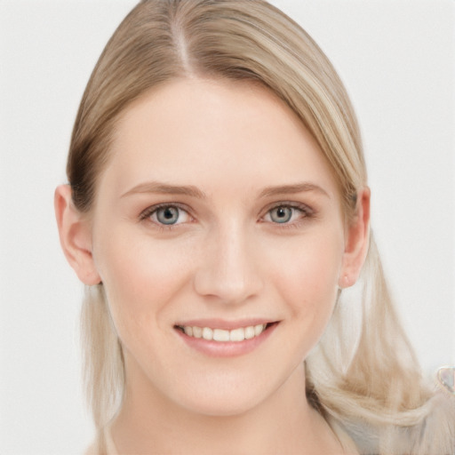 Joyful white young-adult female with long  brown hair and blue eyes