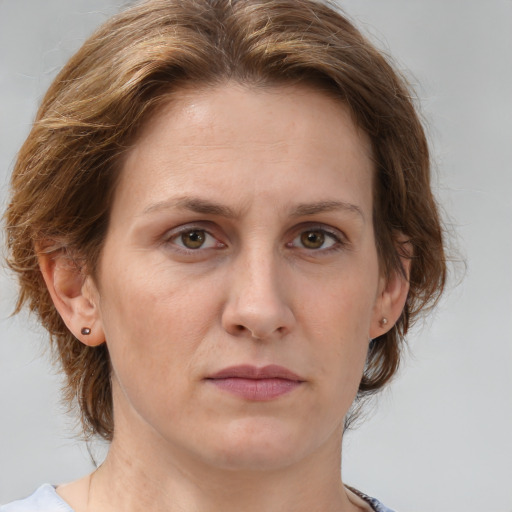 Joyful white adult female with medium  brown hair and grey eyes