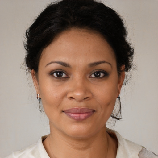 Joyful black young-adult female with medium  brown hair and brown eyes