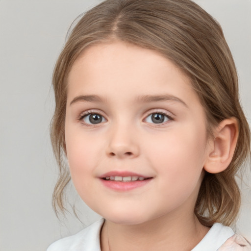 Joyful white child female with medium  brown hair and brown eyes