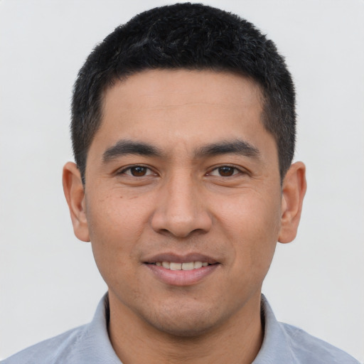 Joyful asian young-adult male with short  brown hair and brown eyes