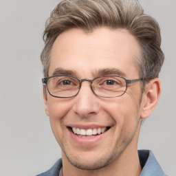 Joyful white adult male with short  brown hair and grey eyes