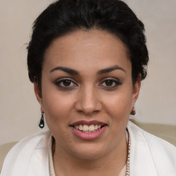 Joyful latino young-adult female with short  brown hair and brown eyes