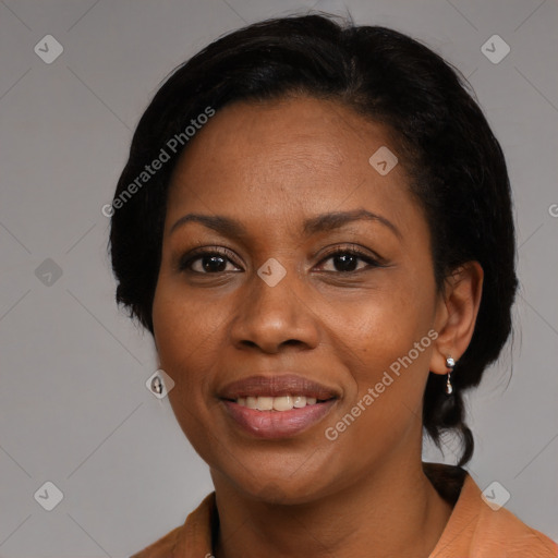 Joyful black adult female with medium  black hair and brown eyes