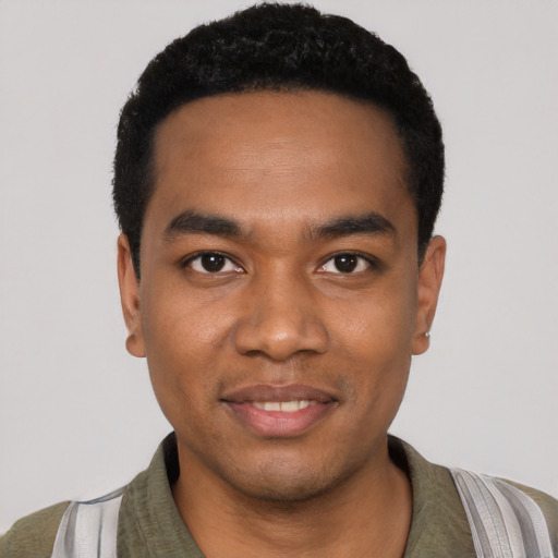 Joyful black young-adult male with short  black hair and brown eyes