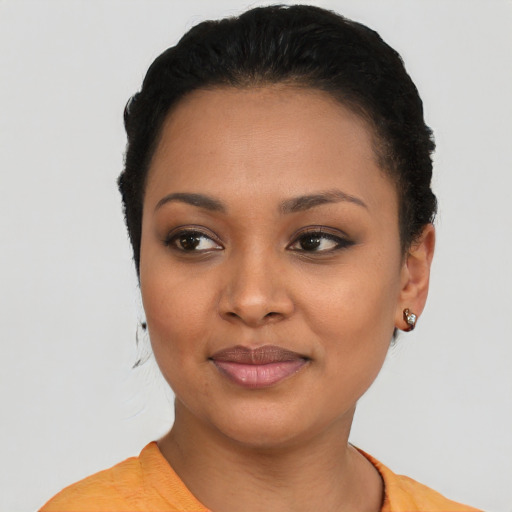 Joyful black young-adult female with short  brown hair and brown eyes