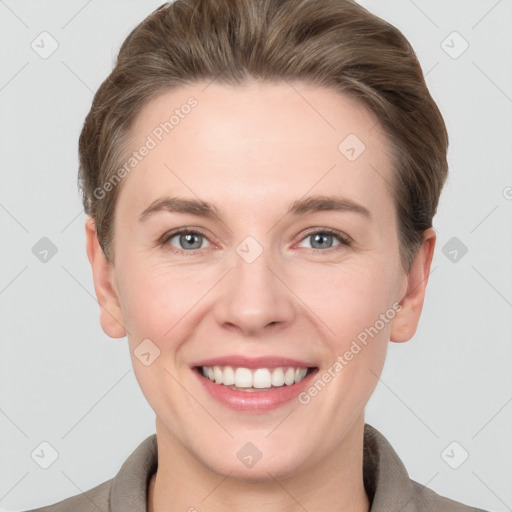 Joyful white young-adult female with short  brown hair and grey eyes