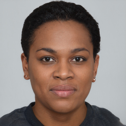 Joyful black young-adult female with short  black hair and brown eyes