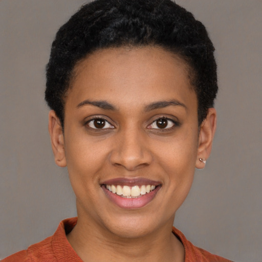 Joyful latino young-adult female with short  black hair and brown eyes