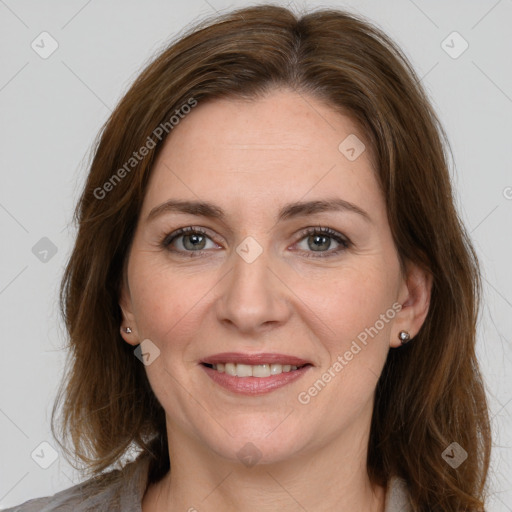 Joyful white adult female with long  brown hair and grey eyes