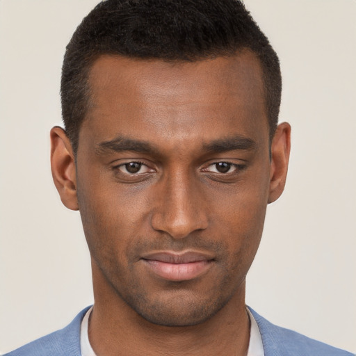 Joyful black young-adult male with short  brown hair and brown eyes