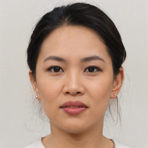 Joyful asian young-adult female with medium  black hair and brown eyes