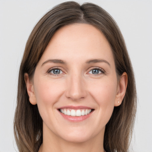 Joyful white young-adult female with long  brown hair and grey eyes