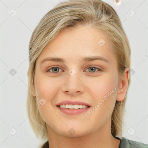 Joyful white young-adult female with long  brown hair and blue eyes