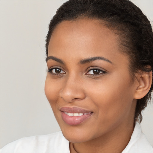 Joyful latino young-adult female with short  brown hair and brown eyes