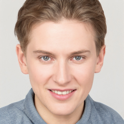 Joyful white young-adult female with short  brown hair and blue eyes