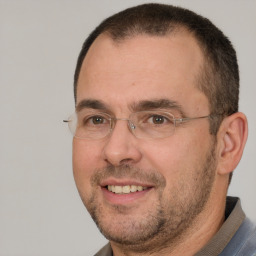 Joyful white adult male with short  brown hair and brown eyes