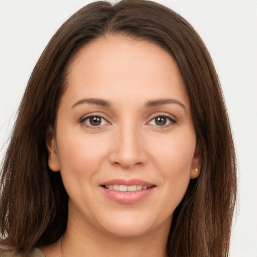 Joyful white young-adult female with long  brown hair and brown eyes