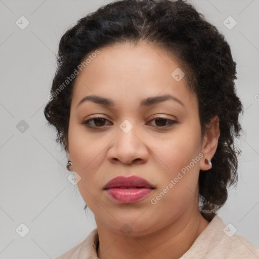 Joyful black adult female with medium  brown hair and brown eyes