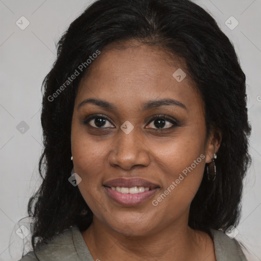Joyful black adult female with long  brown hair and brown eyes