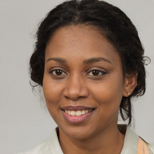 Joyful latino adult female with medium  brown hair and brown eyes