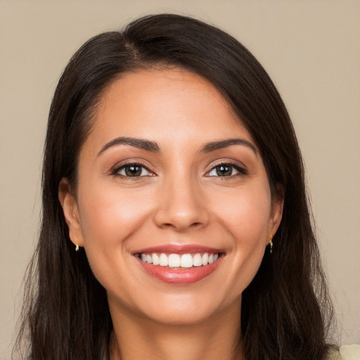 Joyful white young-adult female with long  brown hair and brown eyes