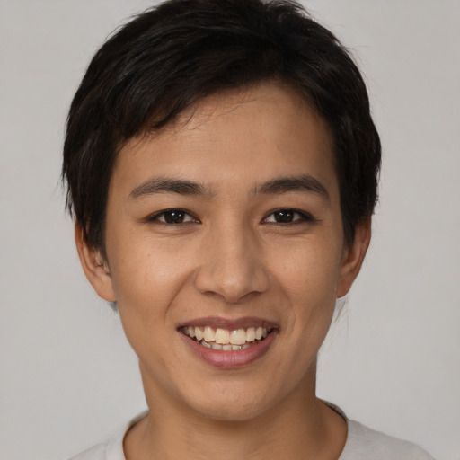 Joyful asian young-adult female with short  brown hair and brown eyes